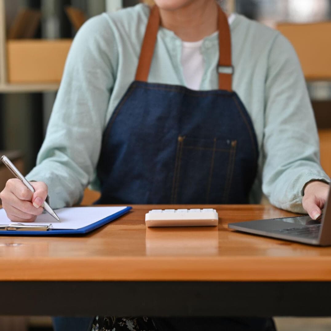 Entrepreneur reviewing business plans and paperwork