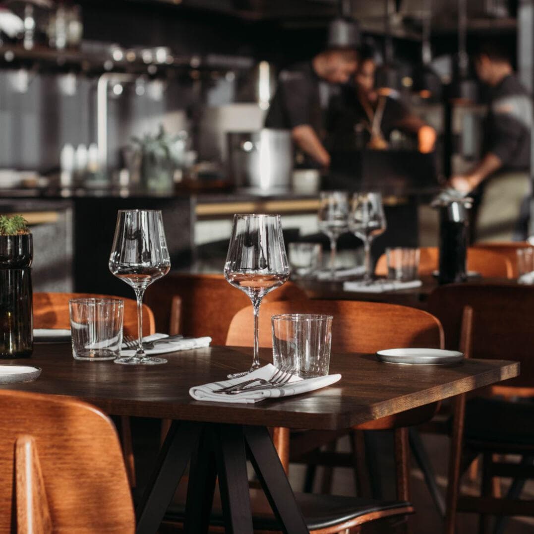 An elegant restaurant table setting with wine glasses